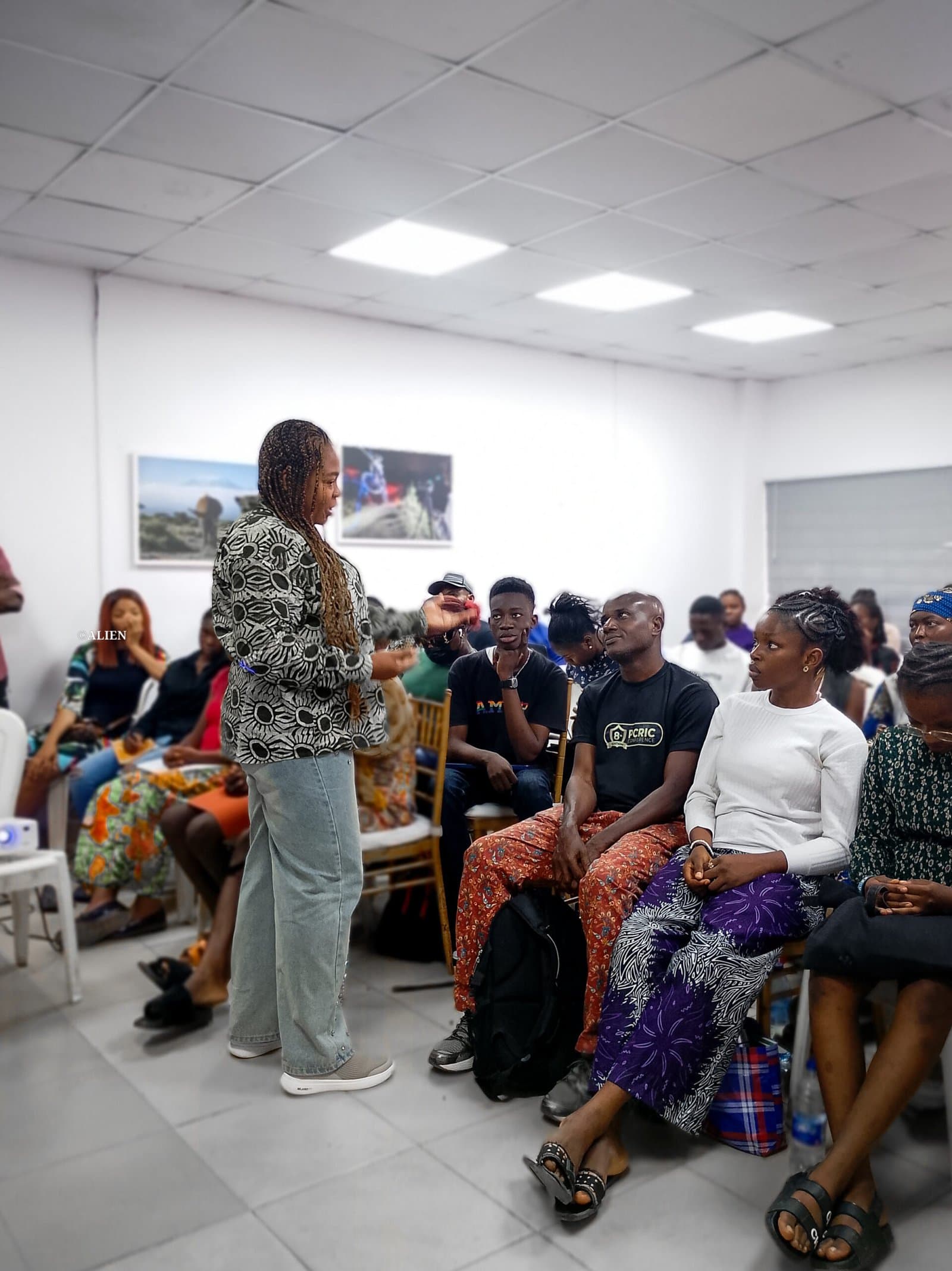 Female facilitator speaking to adult participants during a workshop